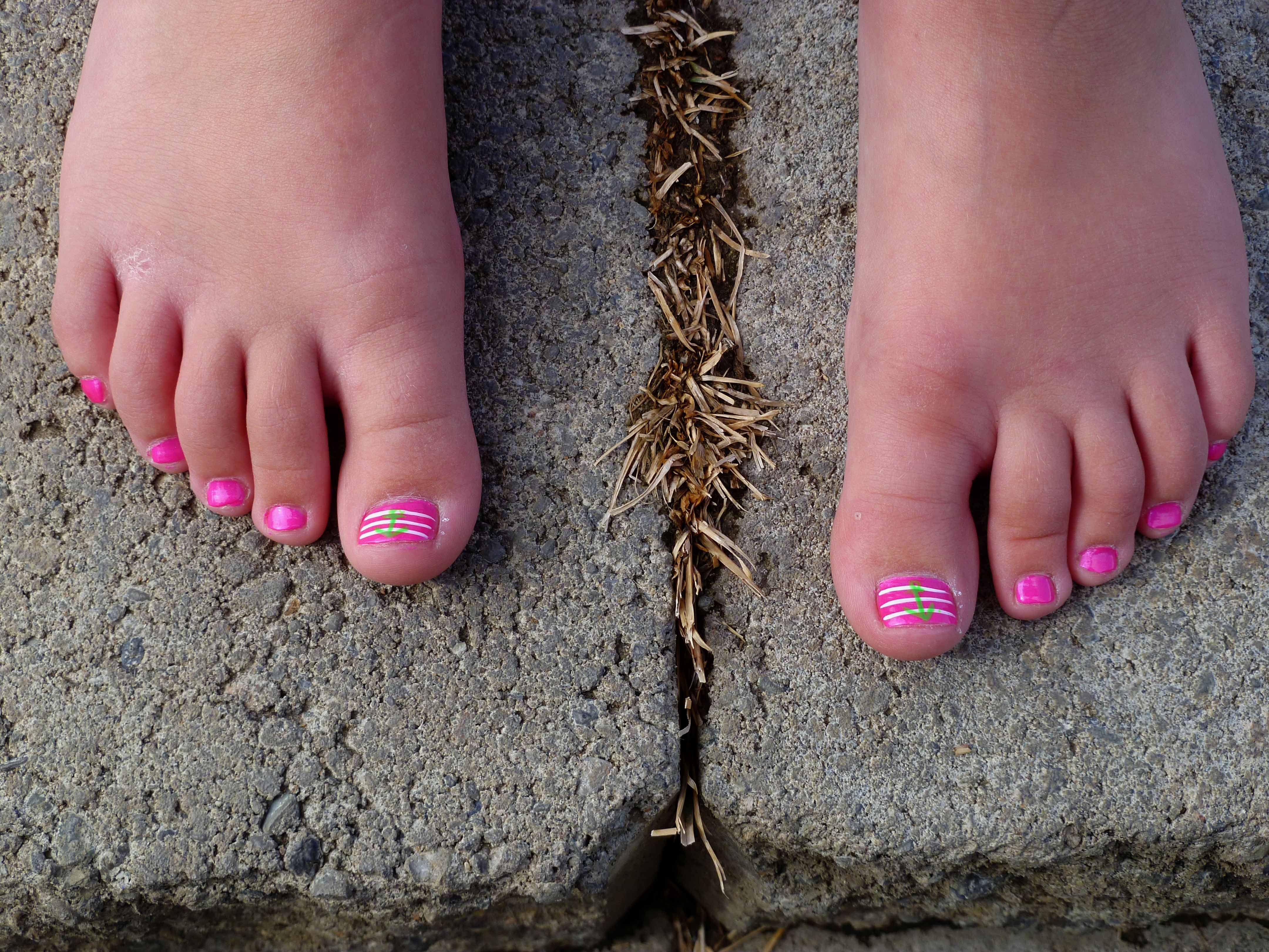 Candid crossed legs painted toes